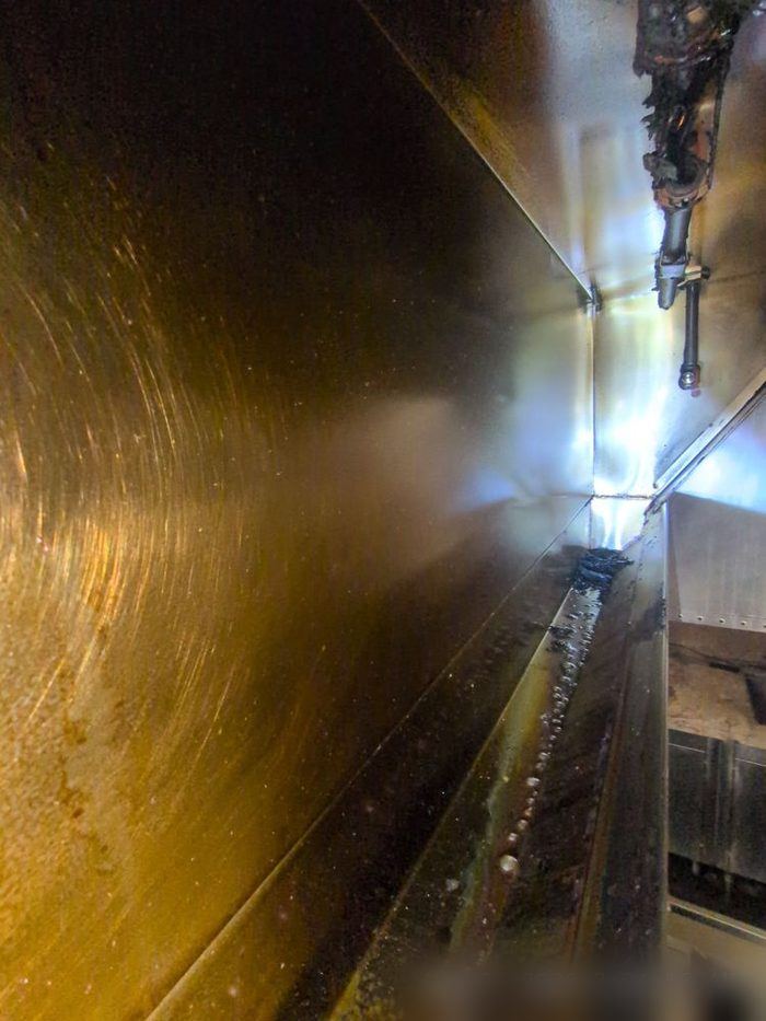 Grease-caked exhaust duct interior before cleaning