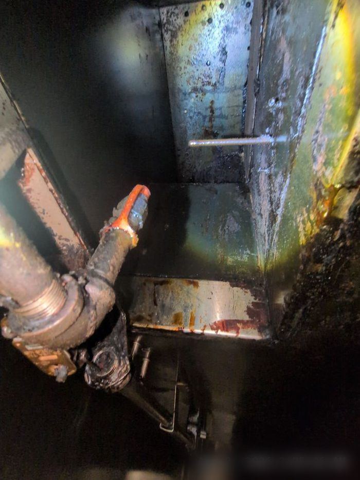 Heavy grease and rust buildup on a hood fan housing